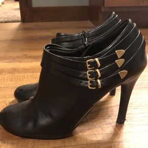 Women’s black heel booties with gold details